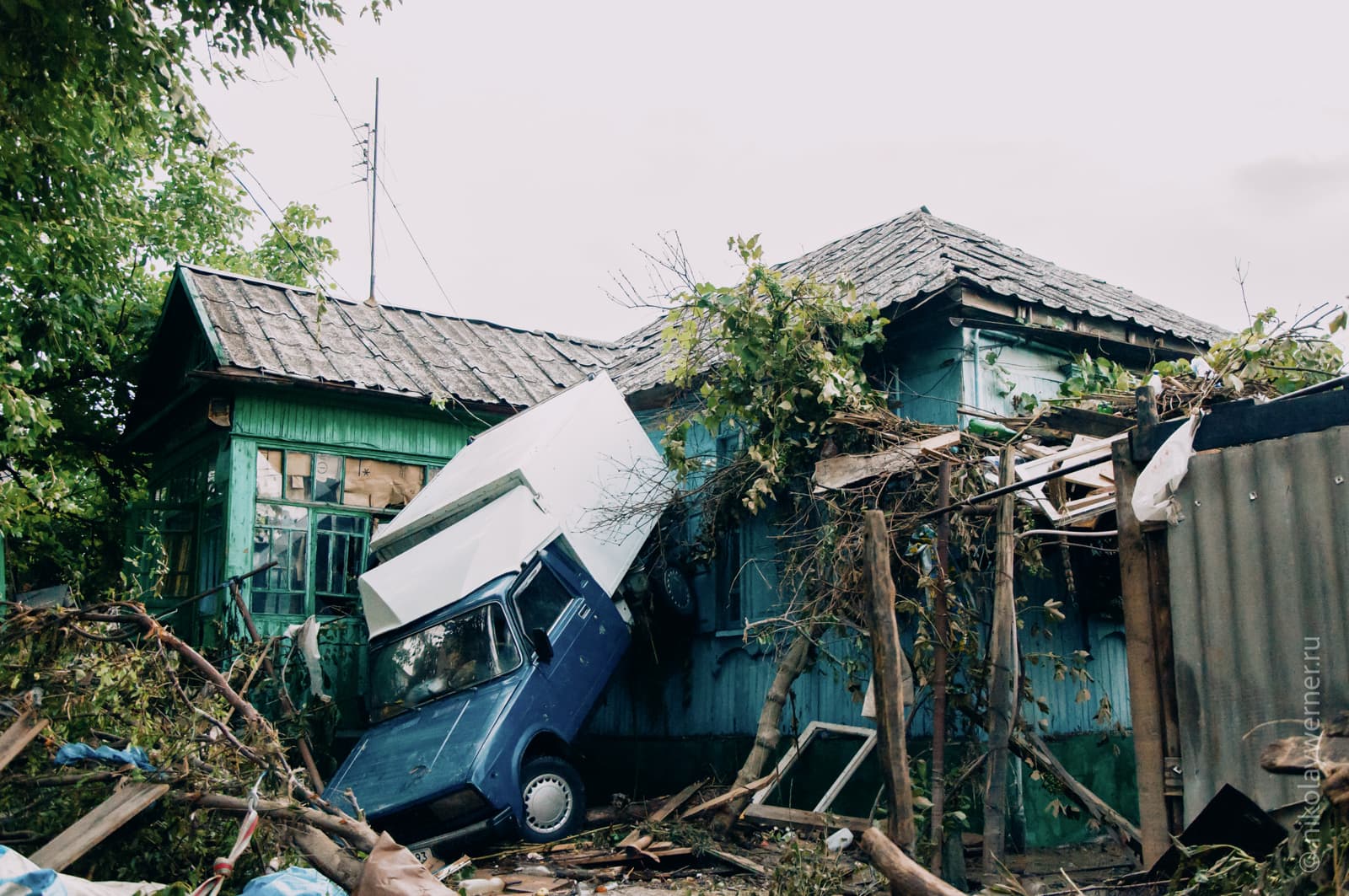 Наводнение в Крымске. Фургон стоит вертикально, отброшенный к стене дома, вокруг горы мусора